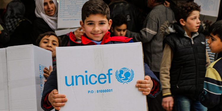 Children laughed aloud in joy at receiving new winter clothes.