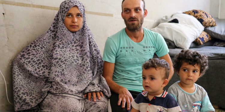 After 8 months following the earthquake, a family awaits the arrival of their newborn in a shelter center